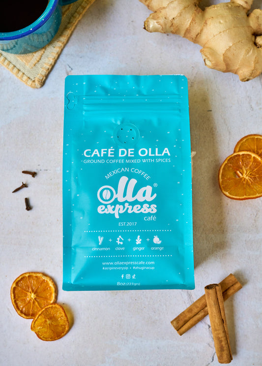 Café de Olla coffee package with dried oranges and cinnamon sticks on a light surface